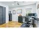 Well-lit home office featuring hardwood floors, a black desk, and a comfortable chair at 1377 Oak Grove Dr, Decatur, GA 30033