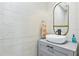 Stylish powder room featuring patterned wallpaper, vanity with sink, and a decorative mirror at 1377 Oak Grove Dr, Decatur, GA 30033