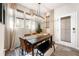 Dining room with a black table, brown leather chairs, and a large window at 648 Glendale Rd, Scottdale, GA 30079