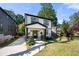 Modern two-story house with white siding and black accents, featuring a welcoming front porch at 648 Glendale Rd, Scottdale, GA 30079