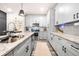 Modern kitchen with gray cabinets, granite countertops, and stainless steel appliances at 648 Glendale Rd, Scottdale, GA 30079