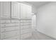 Large walk-in closet with shelving and drawers at 5040 Harrington Rd, Johns Creek, GA 30022