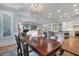 Elegant dining room featuring a large wood table and chandelier at 5040 Harrington Rd, Johns Creek, GA 30022