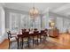 Bright dining room with hardwood floors, large windows, and elegant chandelier at 5040 Harrington Rd, Johns Creek, GA 30022