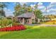 Gated community entrance with lush landscaping and flag at 5040 Harrington Rd, Johns Creek, GA 30022