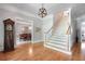 Two-story entryway with hardwood floors, a grand staircase, and views into the dining room at 5040 Harrington Rd, Johns Creek, GA 30022