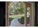 Brick walkway leading to home with arched entryway, showcasing a lush green lawn beyond at 5040 Harrington Rd, Johns Creek, GA 30022