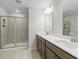 Modern bathroom with double vanity, large shower, and neutral tile at 3750 Willingham Sw Run, Marietta, GA 30008