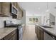 Modern kitchen with granite countertops and wooden cabinets at 3750 Willingham Sw Run, Marietta, GA 30008