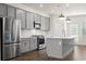 Modern kitchen with gray cabinets, stainless steel appliances, and white backsplash at 3750 Willingham Sw Run, Marietta, GA 30008