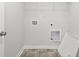 Bright laundry room with tile floor and shelving at 3750 Willingham Sw Run, Marietta, GA 30008