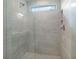 Large walk-in shower with grey tile and glass door at 3750 Willingham Sw Run, Marietta, GA 30008