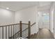 Upstairs hallway with wood floors and modern black railing at 3750 Willingham Sw Run, Marietta, GA 30008