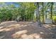 Wooded backyard with playset, shed, and open space at 1790 Aurelia Dr, Cumming, GA 30041