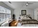 Bright bedroom features hardwood floors, a ceiling fan, and a sunny window with bench seating at 3676 Chattahoochee Summit Dr, Atlanta, GA 30339