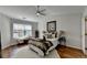 Cozy bedroom with hardwood floors, a ceiling fan, and a sunlit window bench for relaxing at 3676 Chattahoochee Summit Dr, Atlanta, GA 30339