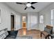 Bright living room featuring hardwood floors, ample natural light, and modern ceiling fan at 3676 Chattahoochee Summit Dr, Atlanta, GA 30339