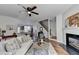 Bright living room featuring hardwood floors, fireplace, modern furniture, and open floor plan to kitchen at 3676 Chattahoochee Summit Dr, Atlanta, GA 30339