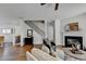 Cozy living room featuring a fireplace, staircase, and hardwood floors at 3676 Chattahoochee Summit Dr, Atlanta, GA 30339