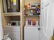 A dedicated laundry space features a side-by-side washer and dryer and shelving for storage at 2700 Pine Tree Ne Rd # 2108, Atlanta, GA 30324