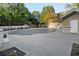 Community pool with a cover surrounded by trees and a clubhouse at 2700 Pine Tree Ne Rd # 2108, Atlanta, GA 30324