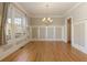 Formal dining room featuring hardwood floors and wainscoting at 6755 Creek View Ln, Cumming, GA 30041