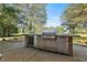 Stainless steel outdoor kitchen with built-in grill and beverage fridge at 160 Isleworth Way, Fayetteville, GA 30215