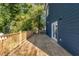 Large wooden deck with railings offers a relaxing outdoor space surrounded by mature trees and lush greenery at 971 Washington Sw Pl, Atlanta, GA 30314