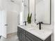 Bright bathroom featuring double sinks, granite counters, and modern fixtures at 971 Washington Sw Pl, Atlanta, GA 30314