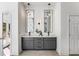 Elegant bathroom with dual vanities, modern lighting fixtures, and access to an outdoor deck at 971 Washington Sw Pl, Atlanta, GA 30314
