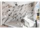 Luxurious bathroom boasts marble tile, freestanding tub, and sleek black fixtures at 971 Washington Sw Pl, Atlanta, GA 30314