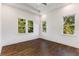 Sunlit bedroom features beautiful hardwood floors and large windows at 971 Washington Sw Pl, Atlanta, GA 30314