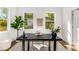 Inviting home office with a sleek black desk, stylish decor, and bright windows offering views of the outdoors at 971 Washington Sw Pl, Atlanta, GA 30314