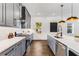 Contemporary kitchen features stainless steel appliances, quartz countertops, and sleek grey cabinetry at 971 Washington Sw Pl, Atlanta, GA 30314