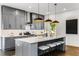 Stylish kitchen with a quartz island, stainless steel appliances, grey cabinets, and trendy pendant lighting at 971 Washington Sw Pl, Atlanta, GA 30314