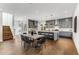 Modern kitchen and dining area featuring stainless steel appliances, island seating and stylish pendant lights at 971 Washington Sw Pl, Atlanta, GA 30314