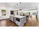 Open-concept kitchen with large island, stainless steel appliances, and seamless flow into the dining and living areas at 971 Washington Sw Pl, Atlanta, GA 30314