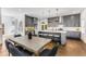Stylish kitchen with gray cabinets, quartz countertops, island seating, and adjacent dining area with modern decor at 971 Washington Sw Pl, Atlanta, GA 30314