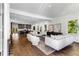 Open-concept living room with hardwood floors, modern furniture, and a view into the kitchen with gray cabinets at 971 Washington Sw Pl, Atlanta, GA 30314
