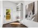 Functional mudroom with built-in shelving, seating, coat hooks, and access to the outdoor deck area at 971 Washington Sw Pl, Atlanta, GA 30314