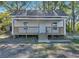 Charming white cottage with a front porch and landscaped yard at 5361 N Main St, Acworth, GA 30101