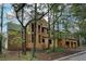 This exterior shot shows a home under construction framed by mature trees on a spacious lot at 440 Allyson Cir, Alpharetta, GA 30009
