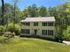 Charming two-story home with a well-manicured lawn and lush green trees providing shade at 26 Flint Ridge Se Dr, Mableton, GA 30126