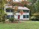 Two-story house with white siding, green shutters, and red front door at 26 Flint Ridge Se Dr, Mableton, GA 30126