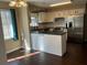 Bright kitchen with white cabinets, dark countertops, stainless steel appliances, and a breakfast bar at 26 Flint Ridge Se Dr, Mableton, GA 30126