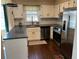 Kitchen featuring white cabinets, dark countertops, stainless steel appliances, and hardwood floors at 26 Flint Ridge Se Dr, Mableton, GA 30126