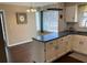 Bright kitchen and breakfast nook area with white cabinets, dark countertops, and stylish pendant lighting at 26 Flint Ridge Se Dr, Mableton, GA 30126
