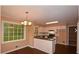 Bright kitchen featuring white cabinets, dark countertops, modern appliances, breakfast bar, and a large window at 26 Flint Ridge Se Dr, Mableton, GA 30126