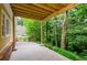 Back patio with wood ceiling and a view of the lush surrounding landscape offering great outdoor living space at 4503 Rivercliff Sw Dr, Lilburn, GA 30047