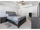 Spacious bedroom with plush carpet and a large TV at 179 Hampton Cir, Mcdonough, GA 30253